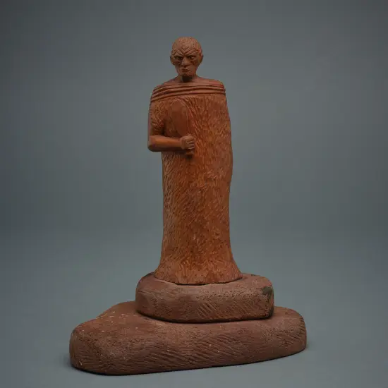 Wooden figure of a Māori rangatira holding patu,